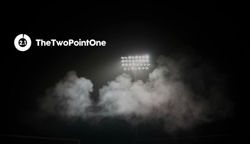'TheTwoPointOne' (2.1) logo displayed next to a floodlight.